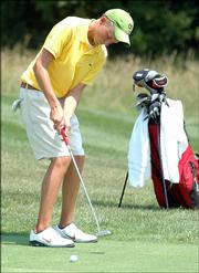 Overland Park's Kyle Smell putts on the No. 10 hole during the final round of the Kansas Golf Assn. Junior Amateur on Thursday at Eagle Bend Golf Course.