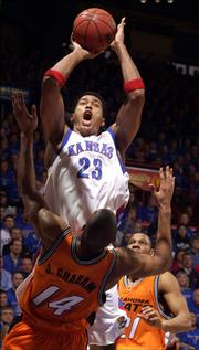 As Oklahoma State's Joey Graham (14) found out, Kansas University's Wayne Simien (23) could be a force inside. Against the Cowboys on Feb. 27, Simien collected 32 points and 12 rebounds in KU's 81-79 victory.