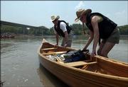 Jeff and Barb Haney, Lecompton, negotiate their canoe into the Kansas River from the newly dedicated boat ramp near the northeast end of the Lecompton bridge.