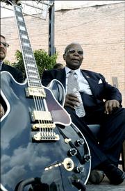 Blues legend B.B. King shares the shade with his beloved guitar, Lucille, while waiting for the groundbreaking ceremonies to begin for the B.B. King Museum and Delta Interpretive Center on June 10 in Indianola, Miss.