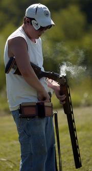 Twelve-year-old Bryan Hull loads his shotgun during a trapshooting session. The Wellsville native practiced last week at Cedar Hill Gun Club near Baldwin.