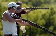Bryan Hull, a 12-year-old from Wellsville, waits his turn to shoot. Hull was practicing with his father, Howard, last week at the Cedar Hill Gun Club near Vinland.