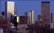 The Denver skyline catches the early morning light in this Dec. 2, 2002, file photo. The state Capitol, the dome of which is seen at center right, is at the southeastern end of the 16th Street pedestrian mall, a mile-long boulevard that runs through the downtown historic district.