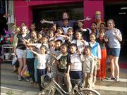 Members of the KU Wind Ensemble take a snapshot with a group of children in China. The band spent 12 days in late May and early June giving performances and master classes in the country.
