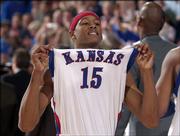 J.R. Giddens holds his head and jersey high following a 90-89 overtime victory against Iowa State on Feb. 21, 2004 at Allen Fieldhouse. The Jayhawks announced Thursday that Giddens was leaving the program and transferring to another school.