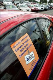 A window sticker announces General Motors Corp.'s employee discount promotion at Jim Causley Pontiac GMC in Mount Clemens, Mich. GM's sales soared 41 percent in June to their highest monthly total in nearly 19 years thanks to a heavily-promoted discount that allowed customers to buy vehicles at the employee rate.