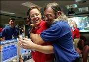 Dan Kubitschek, left, and Steve Collins celebrate the collision of NASA's Deep Impact spacecraft with the comet Tempel 1 Sunday night in Mission Control at the Jet Propulsion Laboratory in La Canada Flintridge, Calif.