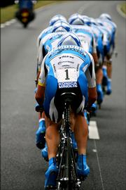 Team Discovery Channel riders, with leader Lance Armstrong in the foreground, ride in the fourth stage of the Tour de France. The Discovery team won Tuesday's stage between Tours and Blois, France, and Armstrong took the overall leader's yellow jersey.
