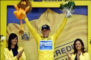 Overall leader and six-time champion Lance Armstrong waves from the podium after the sixth stage of the Tour de France.