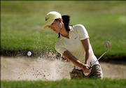 Michelle Wie hits out of a bunker on the second hole. Wie shot a 1-under 70 Thursday in the John Deere Classic at Silvis, Ill.