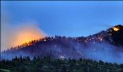 Trees are seen engulfed in flames late Saturday near Wetmore, Colo. Fire crews were stationed throughout the Greenwood community 25 miles west of Pueblo, about 100 miles south of Denver.