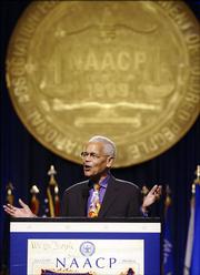 Julian Bond, chairman of the board of the National Association for the Advancement of Colored People, speaks Sunday at the Opening of the NAACP 96th annual convention at the Midwest Airlines Center in Milwaukee.