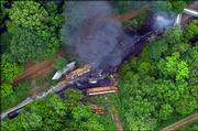 The wreckage of two freight trains that collided Sunday near Bentonia, Miss., burns. Yazoo County authorities said they had recovered the body of one crew member and were searching the wreckage for three others.