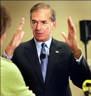 Sprint Corp. chairman and CEO Gary Forsee talks with reporters following the Sprint shareholders meeting Wednesday in Overland Park. At the meeting at least 96 percent of shareholders approved the acquisition of Nextel.