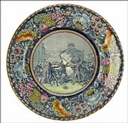 The Boston Massacre of 1770 is pictured on this blue transfer plate. The border has been colored. It was made in the early 1900s; it's a reproduction of a much earlier plate.