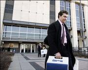 Former Westar Energy Inc. executive David Wittig leaves the federal courthouse Dec. 20 in Kansas City, Kan. Wittig's first federal fraud trial ended in a mistrial after jurors could not reach a verdict on more than half the charges. Wittig's second trial is under way.