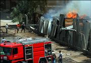 Iraqi firefighters battle a fire after a car bomb attack targeting a U.S. military convoy in the area east of Baghdad, Iraq, on Friday. A series of car bombs targeted U.S. and Iraqi troops in separate areas of the Iraqi capital, a day after security forces captured a would-be suicide bomber near the entrance to the heavily guarded Green Zone. Scattered mortar fire shook two north Baghdad districts.