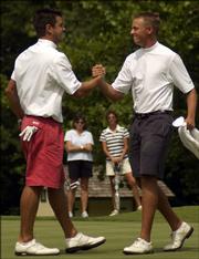 Kansas University teammates Gary Woodland, left, and Tyler Docking celebrate their KGA Four-Ball victory. Woodland's putt on the fourth playoff hole ended Monday's match against Missouri golfers Chris Mabry and John Kelly at Alvamar Golf Course.