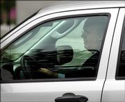 Karl Rove, President Bush's deputy chief of staff and political adviser, is seen driving away on West Executive Drive near the White House on Tuesday in Washington. Rove is at the center of a controversy about the leaking of a CIA operative's identity, which originally appeared in Robert Novak's newspaper column.