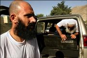 Former Afghan Guatanamo prisoners Moheb Ullah Borekzai, left, and Habir Russol exit a car after being released Wednesday after a detention at Guantanamo Bay in Cuba. They claim about 180 other Afghans held at the U.S. detention facility were on a hunger strike to protest alleged mistreatment. They say they did not participate in the hunger strike.