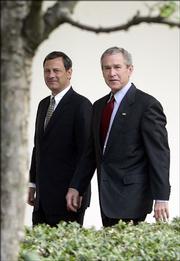 President Bush and his nominee for the Supreme Court, John Roberts, walk together after meeting Wednesday at the White House. Supreme Court nominee John G. Roberts began his confirmation campaign to nail down Republican Senate support and overcome Democrats' fears that he would push the nation's highest court far to the right on abortion and other polarizing issues.