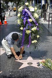 Jimmy Hernandez places flowers on the star of actor James Doohan, best known as the burly chief engineer Montgomery "Scotty" Scott of the Starship Enterprise in the original "Star Trek" TV series. Doohan died Wednesday at his home in Redmond, Wash. The cause of death was pneumonia and Alzheimer's disease.
