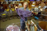 Penn House sorter, Perry Hartman, Lawrence, begins folding clothes Wednesday at the thrift shop at 1035 Pa. Hartman and other employees are expecting a greater influx of donations now that the Salvation Army Thrift Store, formerly at 1818 Mass., has closed.