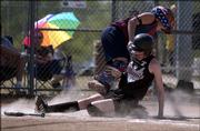Lawrence's Rose Griffin, foreground in photo above, slides into catcher Kayla Sears during the Phenix's 12-2 rout of the Augusta Chill. The Phenix won Friday at the Youth Sports Inc. fields.