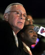 Larry Brown listens to questions at a news conference after being introduced by general manager Isiah Thomas, right, as the new coach of the New York Knicks. Brown was introduced Thursday in New York.