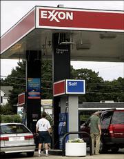 Customers fill up at the self-service pumps at an Exxon gas station in Woburn, Mass. Exxon Mobil Corp., the world's largest publicly traded oil company, reported a 32 percent increase in second-quarter profits as it reaped the benefits of soaring oil and natural gas prices.