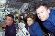 Astronauts Eileen M. Collins, mission commander, Stephen K. Robinson, left, mission specialist, and James M. Kelly, pilot, aboard Discovery on Thursday.