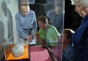 From left, Jim Huss, Atchison, Vita Tucker, Burlingame, Chris Garst, Topeka, and Anne Greitl, Topeka, view a pair of dinosaur egg fossils on display at the Kansas Museum of History in Topeka. A delegation from Henan Province in China presented the eggs to Gov. Kathleen Sebelius as a gift to Kansas. Huss, Tucker and Greitl are all volunteers at the museum, and Garst is the archeology lab supervisor. The four were viewing the eggs for the first time. The eggs could find a permanent home at Kansas University or in the Sternberg Museum in Hays.