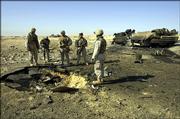 U.S. Marines on Thursday inspect the site where a roadside bomb destroyed their lightly armored vehicle Wednesday, killing 14 Marines and a civilian interpreter in Barwana, near Haditha, Iraq. This was the deadliest roadside bombing suffered by American forces in the Iraq war.
