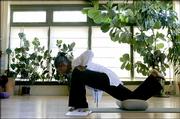 Mary Imani, a yoga teacher at 8 Limbs Yoga Center in Seattle, leads a July 26 class. Even though the slow stretches and meditations of yoga don't burn calories like a run on the treadmill, a new study indicates that it might help people lose or maintain weight in their middle ages.