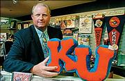 Paul Vander Tuig is in charge of Kansas University's trademarks. He shows some examples of KU products at the Kansas Union.