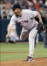 Boston pitcher Tim Wakefield throws in the seventh inning against the Minnesota Twins. Wakefield helped the Red Sox win, 11-7, Sunday in Minneapolis.