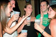 From left, Meghan Zavodny, a KU medical student from Shawnee; Matt Ross, a Shawnee senior; Eliza Zahn, a Littleton, Colo., graduate, and friends Aaron Gardner, of McLouth, and Kristen Camardelle, Mission; drink beers at the Cadillac Ranch, 2515 W. Sixth St. Zahn kept track of her budget during spring 2005 and says that going out was a major expense.