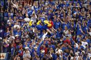KU fans pass Big Jay after a touchdown against Kansas State in KU's 31-28 victory over their in-state rivals at Memorial Stadium in Lawrence.