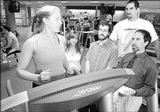 Kansas University psychology graduate students, from left, Jennifer Prohaska, Leslie Karwoski, Andy Lehman, Chris Heath and professor Steve Ilardi are working on an alternative to drug therapy for treating depression. The group is pictured at the KU Student Recreation Center, which opened in September 2003.