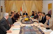 Iraq's President Jalal Talabani, center rear, speaks to political leaders during a national meeting to discuss issues in the drafting of Iraq's new constitution in the run up to the mid-August deadline Sunday in Baghdad, Iraq. Talabani urged a spirit of compromise as political leaders gathered Sunday to try to resolve differences over a constitution that is supposed to be approved by parliament in eight days.