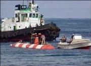 Crew members of the Russian mini-submarine and rescue team members stand on its hull shortly after the sub surfaced in the Beryozovaya Bay about 10 miles off the Kamchatka coast Sunday in this image taken from television.