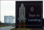 A sign near Kennedy Space Center's vehicle assembly building remains unchanged Monday morning, hours after NASA decided to scrub the landing of space shuttle Discovery. Bad weather in Florida forced NASA to delay the shuttle's landing to just after 4 a.m. CDT this morning.