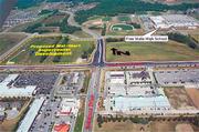 This aerial photo shows the intersection of Sixth Street and Wakarusa Drive at center and to the northwest of the intersection the land where Wal-Mart would like to build a superstore. Sixth Street runs across the photo from east to west. Lawrence Free State High School is visible to the northeast of the intersection in the upper right. Westgate Center shops and People's Bank are visible in the lower right of the frame just east of Wakarusa Drive.