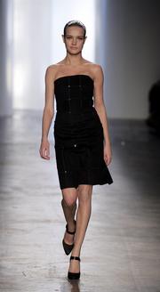 A model wears a black cashmere-sequin strapless dress with a grid pattern from Calvin Klein Collection's fall line.