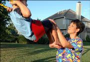 Natalie Griego pushes her 4-year-old son, Reece Griego Krall, on the swingset in their backyard. Griego will be leaving for her second tour in Iraq as a physician and will be away from her family for more than three months.