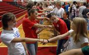 In the foreground, Lawrence High School sophomores Ashley Caldwell, left, and Kali Howell, right, meet seniors, in Lena Tsiovkh, left and Stephanie Gaines, right. Sophomores were teamed with senior leaders Wednesday for their first experience in the high school environment. The first full day of school is today.