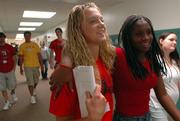 Lawrence High School sophomores and friends Ciara Girame, left, and Janae Colter, meet in the hallway while participating in orientation activities on their first day at school. Sophomores were teamed with upperclassmen Wednesday for their first experience in the high school environment. The first full day of school is today.