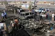 Iraqi soldiers and police officers secure the area around one of the two massive car bombs that exploded at a bus station in Baghdad, Iraq. Two car bombs driven by suicide attackers exploded Wednesday morning at the al-Nahda bus station in central Baghdad. Another bomb exploded a short time later at a hospital where many of the wounded were taken.