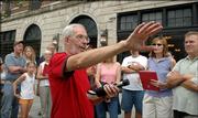 John Jewell, of the Watkins Community Museum, above, talks Saturday about William Quantrill's raid on Lawrence during a walking tour of sites involved in the raid. Jewell is in front of the Eldridge Hotel, which originally was the Free State Hotel and was burned down by Quantrill in the raid.