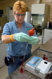 Donna Tucker, a city water treatment plant operater, tests some water to measure the amount of fluoride in Lawrence's water supply. The city attempts to keep fluoride around 1 part per million, within the recommended guidelines of 0.7 to 1.2 ppm.